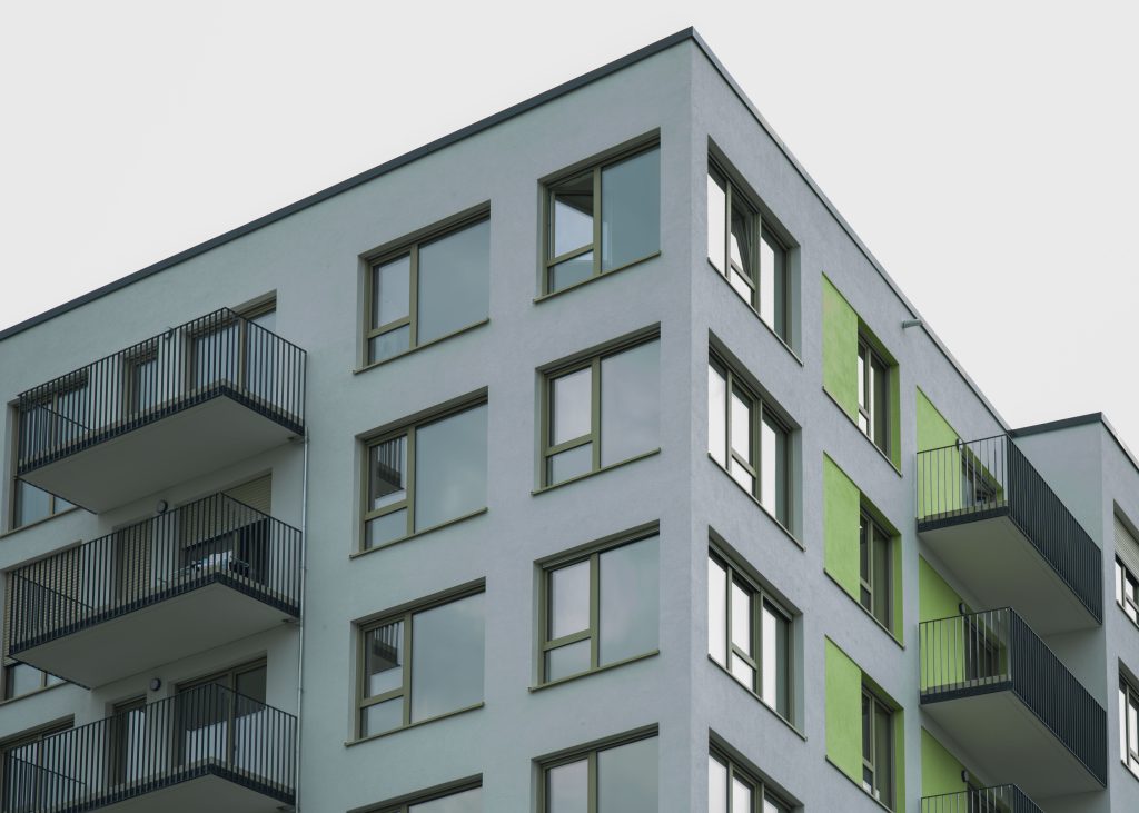 Modern apartment building exterior representing premises that require a fire risk assessment to ensure legal compliance and resident safety.