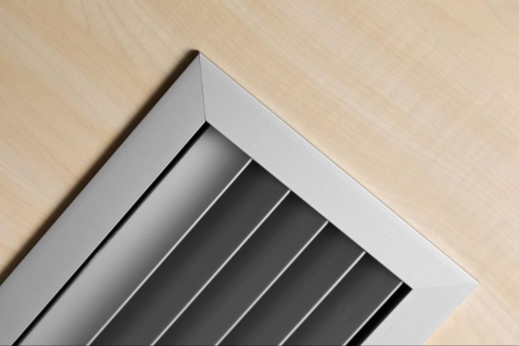 Ceiling-mounted smoke ventilation grille as part of a smoke control system, illustrating smoke vent testing requirements, inspection frequency and British Standards compliance.