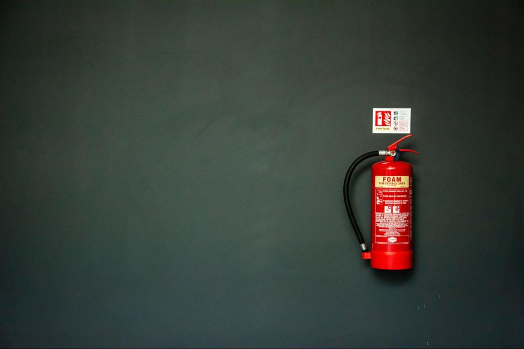 Wall-mounted foam fire extinguisher with identification signage, illustrating the importance of fire extinguisher maintenance, inspection, testing and servicing for fire safety compliance.